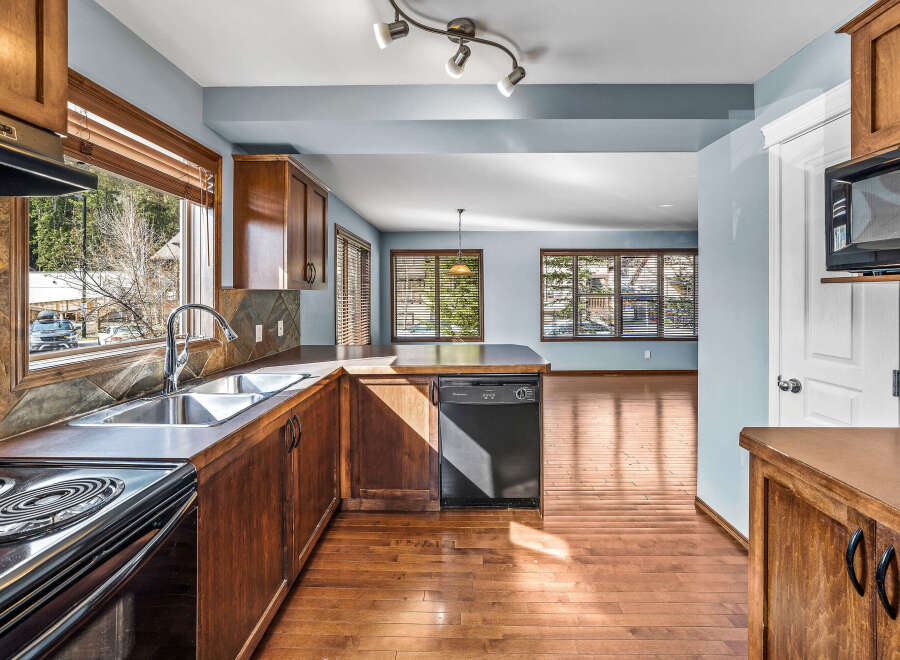 Step into this inviting kitchen, featuring warm wooden cabinetry and sleek appliances.