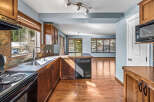 Step into this inviting kitchen, featuring warm wooden cabinetry and sleek appliances.