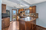 This stunning kitchen boasts rich, dark wood cabinetry and flooring, creating a warm and inviting atmosphere.