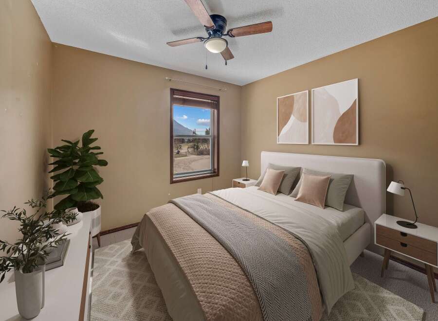 Step into this inviting bedroom, featuring a cozy bed and stylish decor.