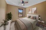 Step into this inviting bedroom, featuring a cozy bed and stylish decor.