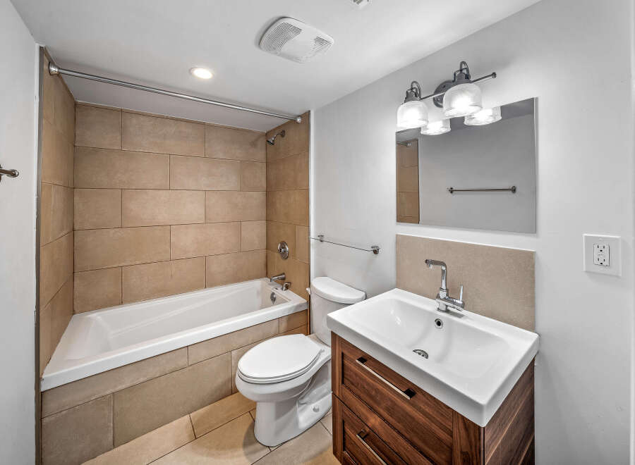 Step into this beautifully designed bathroom featuring a modern vanity and a sleek, white sink.