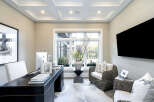 Step into luxury with this stunning home office, featuring a sleek desk and a comfortable seating area.