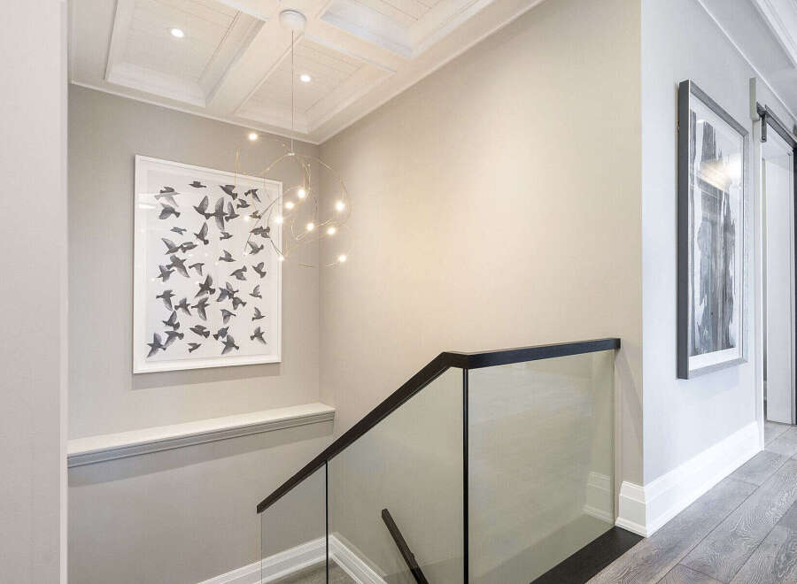 This stunning property features a modern staircase with a glass railing, offering a sleek and contemporary design.