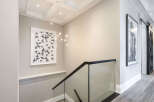 This stunning property features a modern staircase with a glass railing, offering a sleek and contemporary design.