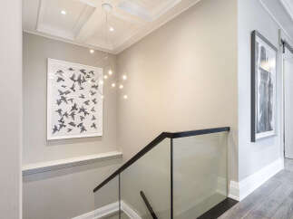This stunning property features a modern staircase with a glass railing, offering a sleek and contemporary design.