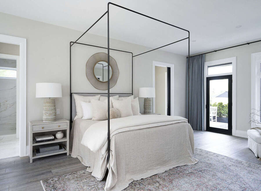 Step into luxury with this stunning bedroom featuring a modern canopy bed and elegant decor.