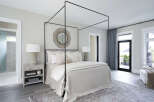 Step into luxury with this stunning bedroom featuring a modern canopy bed and elegant decor.