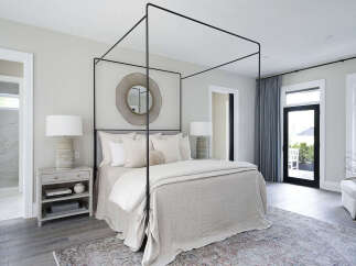 Step into luxury with this stunning bedroom featuring a modern canopy bed and elegant decor.