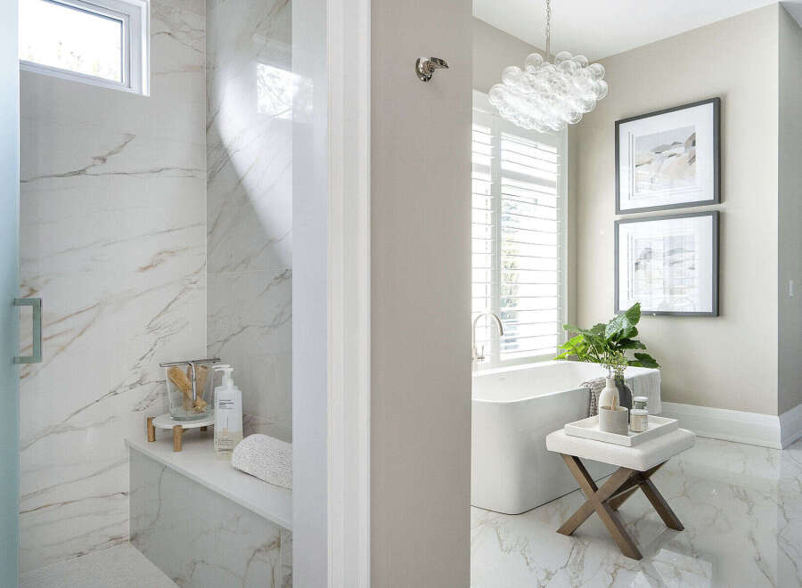 Step into luxury with this stunning bathroom featuring exquisite marble finishes and a spa-like ambiance.