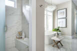 Step into luxury with this stunning bathroom featuring exquisite marble finishes and a spa-like ambiance.
