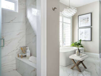 Step into luxury with this stunning bathroom featuring exquisite marble finishes and a spa-like ambiance.