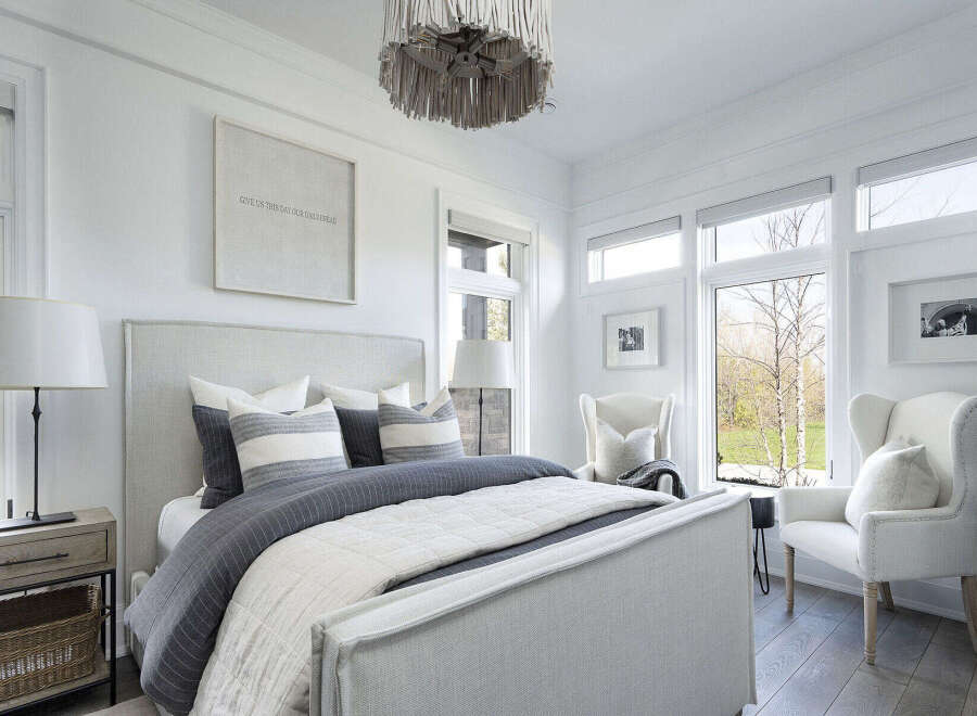 This stunning bedroom offers a serene retreat with its elegant design and ample natural light.