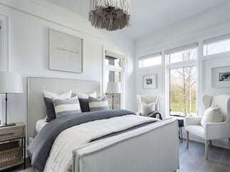 This stunning bedroom offers a serene retreat with its elegant design and ample natural light.