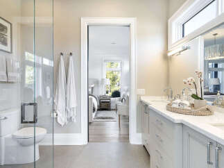 Step into luxury with this stunning bathroom, featuring a sleek design and modern amenities.