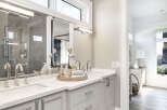 This luxurious bathroom boasts a modern design with a sleek vanity and ample counter space.