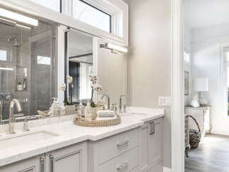 This luxurious bathroom boasts a modern design with a sleek vanity and ample counter space.