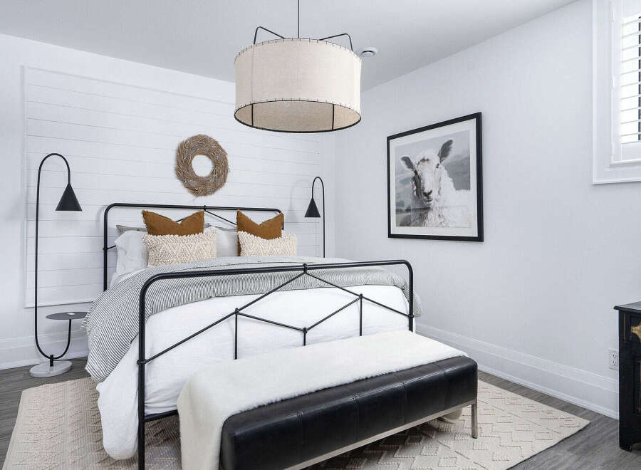 Step into a serene bedroom retreat, designed with a blend of modern and rustic elements.