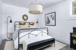 Step into a serene bedroom retreat, designed with a blend of modern and rustic elements.