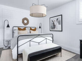 Step into a serene bedroom retreat, designed with a blend of modern and rustic elements.