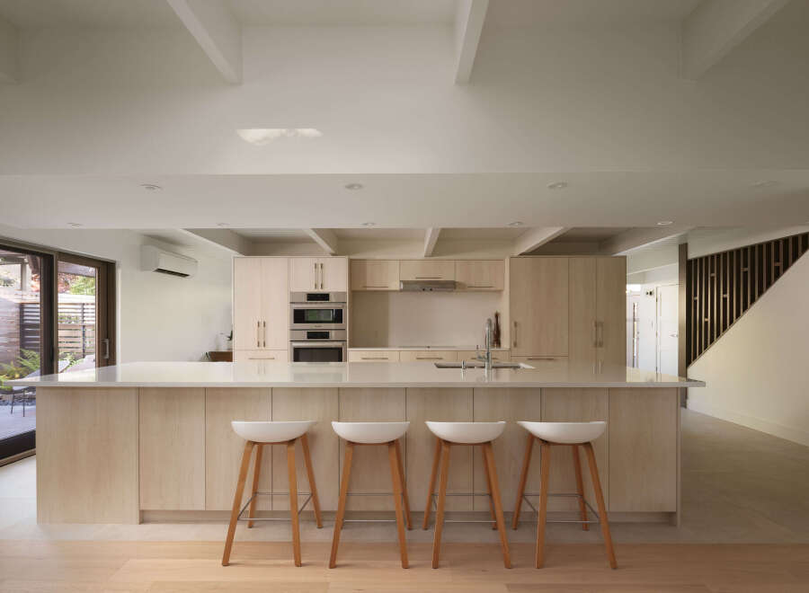 This modern kitchen boasts a sleek design with light wood cabinetry and a spacious island.