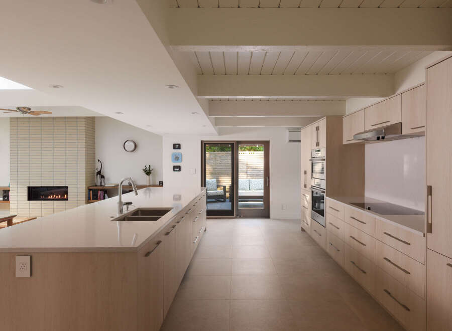 This modern kitchen boasts a sleek design with ample counter space and stylish cabinetry.