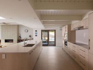This modern kitchen boasts a sleek design with ample counter space and stylish cabinetry.