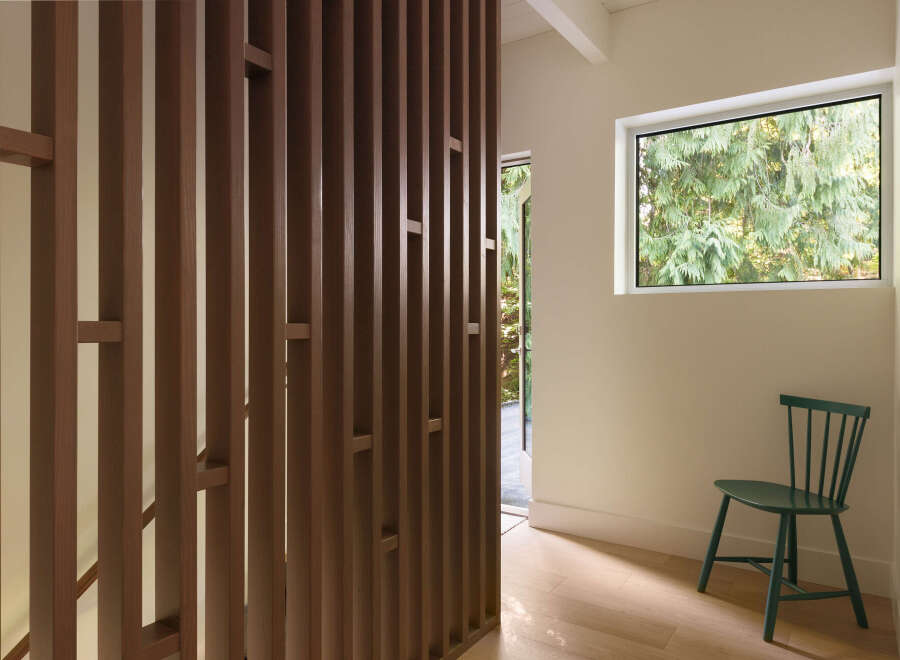 This stunning property features a modern design with a unique wooden slat wall, creating a stylish and inviting atmosphere.