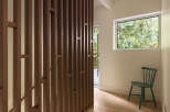 This stunning property features a modern design with a unique wooden slat wall, creating a stylish and inviting atmosphere.