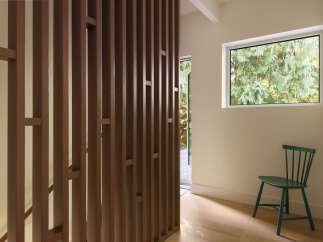 This stunning property features a modern design with a unique wooden slat wall, creating a stylish and inviting atmosphere.
