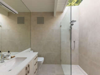 This modern bathroom boasts a sleek design with neutral tones and high-end finishes.