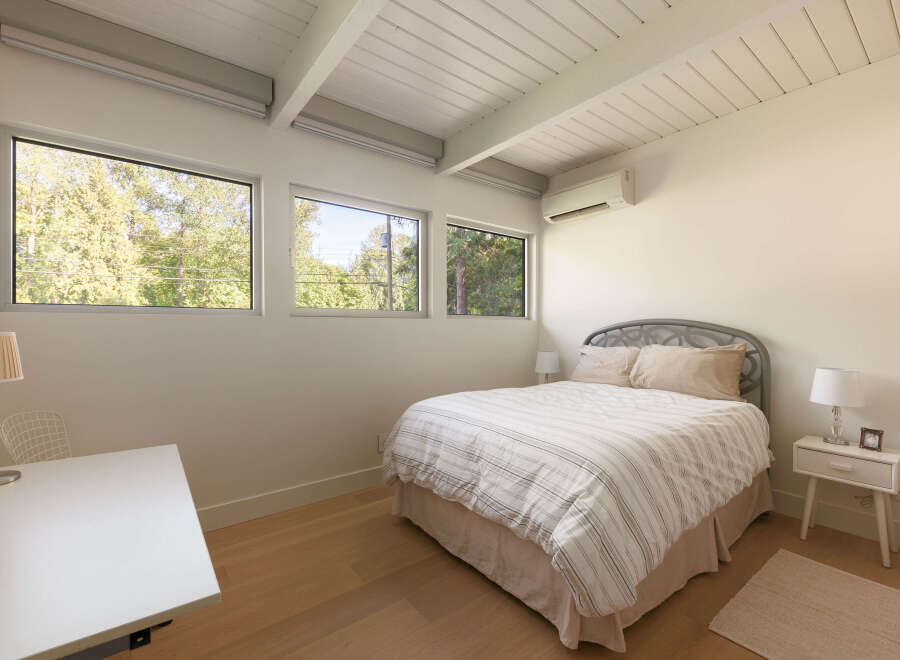 This bright and airy bedroom features a modern design with clean lines and natural light.