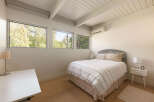 This bright and airy bedroom features a modern design with clean lines and natural light.