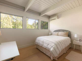 This bright and airy bedroom features a modern design with clean lines and natural light.
