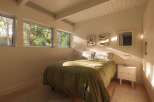 This serene bedroom offers a tranquil retreat with its minimalist design and natural light.
