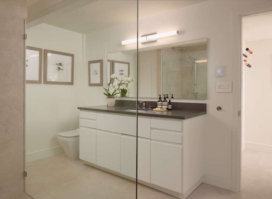 This modern bathroom boasts a sleek design with clean lines and a neutral color palette, creating a serene and inviting atmosphere.