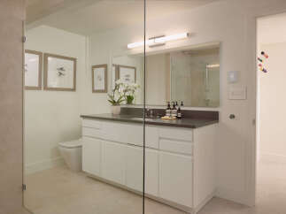 This modern bathroom boasts a sleek design with clean lines and a neutral color palette, creating a serene and inviting atmosphere.