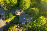 This stunning property boasts a modern architectural design, seamlessly blending with its lush, green surroundings.