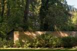 Discover the tranquility of this stunning property, featuring lush greenery and a beautifully crafted wooden fence.