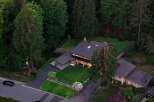 Discover a stunning modern home nestled in a lush, wooded setting.