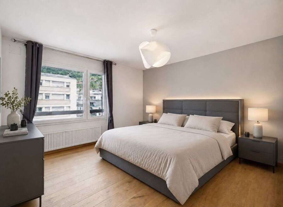 Step into this serene bedroom, featuring a modern design with a comfortable bed and stylish decor.