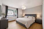Step into this serene bedroom, featuring a modern design with a comfortable bed and stylish decor.
