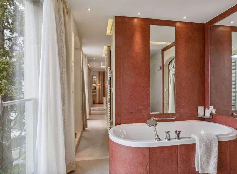 Indulge in luxury within this exquisite bathroom, featuring a stunning bathtub and elegant design.