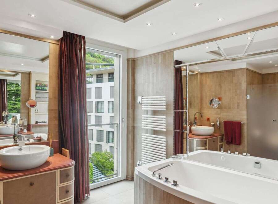 Indulge in luxury within this exquisite bathroom, featuring a sleek soaking tub and elegant vanity.