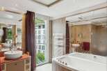 Indulge in luxury within this exquisite bathroom, featuring a sleek soaking tub and elegant vanity.