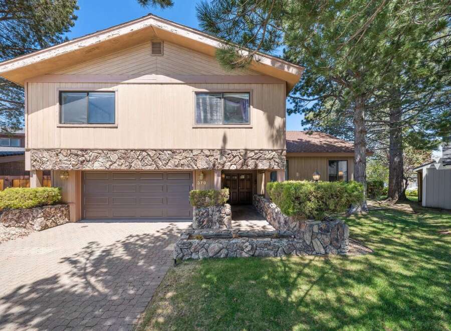 Discover this stunning property featuring a beautiful stone facade and a welcoming entrance.