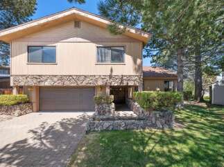 Discover this stunning property featuring a beautiful stone facade and a welcoming entrance.