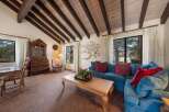 Step into this inviting living space, featuring a stunning vaulted ceiling with exposed beams.