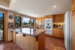 This stunning kitchen boasts a spacious island with a sleek countertop, perfect for meal preparation and entertaining.