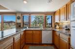 This stunning kitchen boasts beautiful wooden cabinetry and granite countertops, creating a warm and inviting atmosphere.